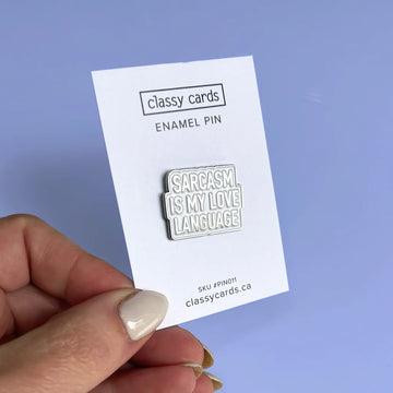 Sarcasm Love Language Enamel Pin - White enamel pin with silver outline and text "Sarcasm is my love language" on a backing card, handmade Canadian gift.