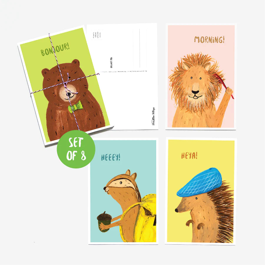 A green postcard with a brown bear and "Bonjour!"; a pink card with a lion brushing his mane and "Morning!"; a blue card with a chipmunk with a yellow backpack holding an acorn and "Heeey!"; a yellow card with a porcupine wearing a blue newsboy hat and "Heya!"