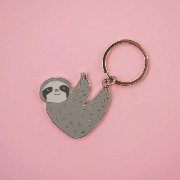 A grey sloth hanging from the key ring from his feet