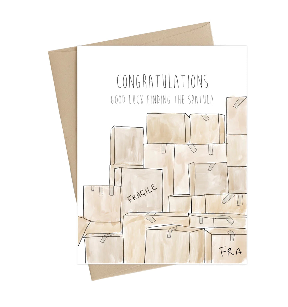 A white card with illustrated cardboard boxes piled high, two are labelled fragile. Above the pile in black font reads "Congratulations Good luck finding the spatula"