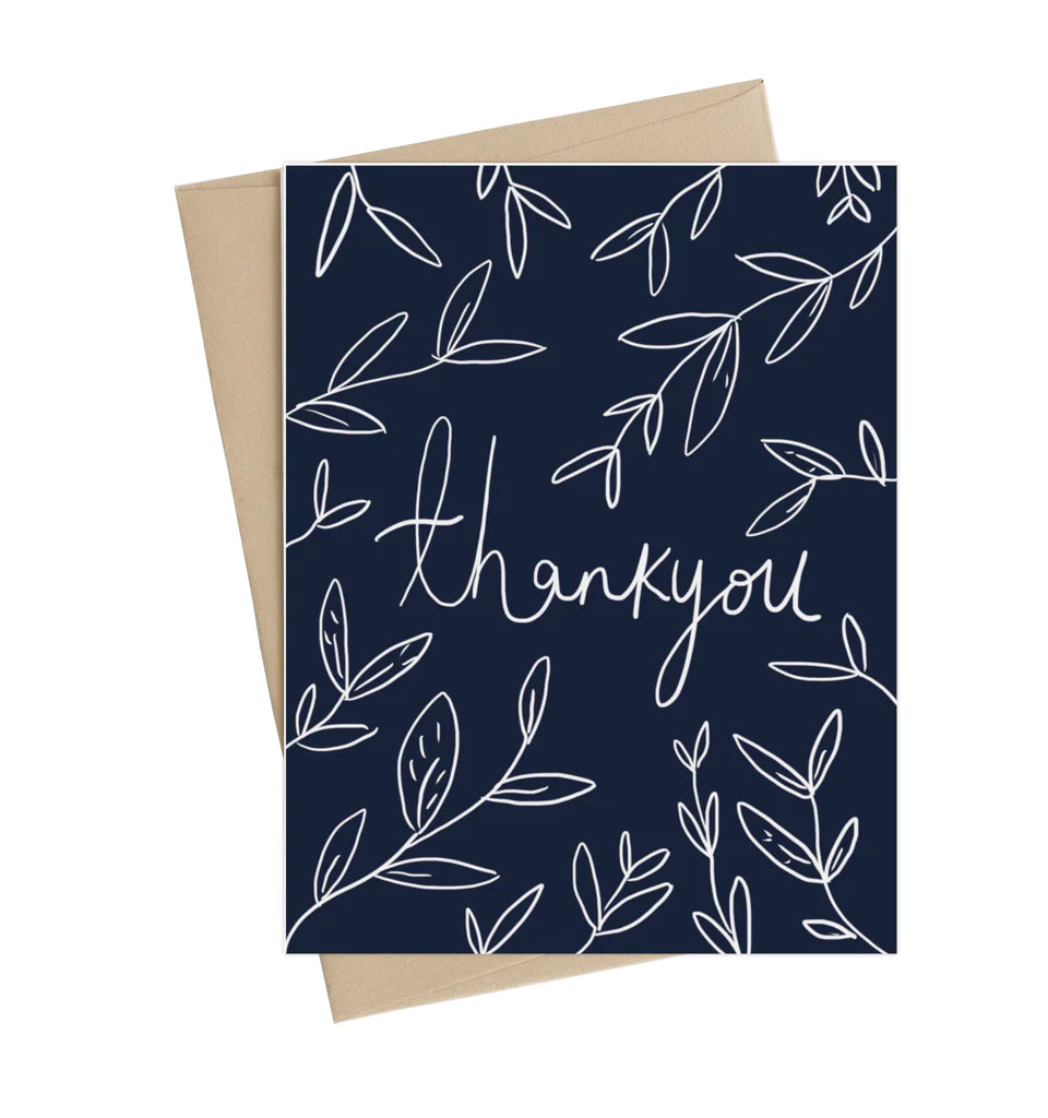 A black card with white vines and leaves surrounding a cursive "thank you" in the center of the card