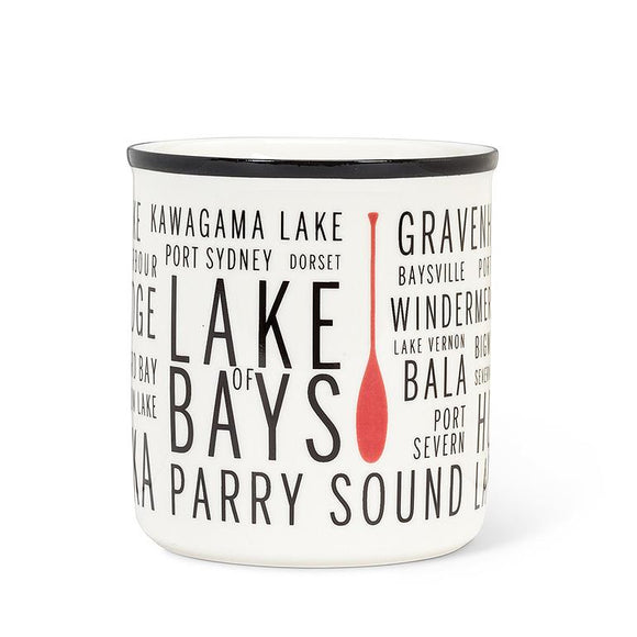 White mug with a black rim, a red canoe oar, and black text listing names of Muskoka lakes.