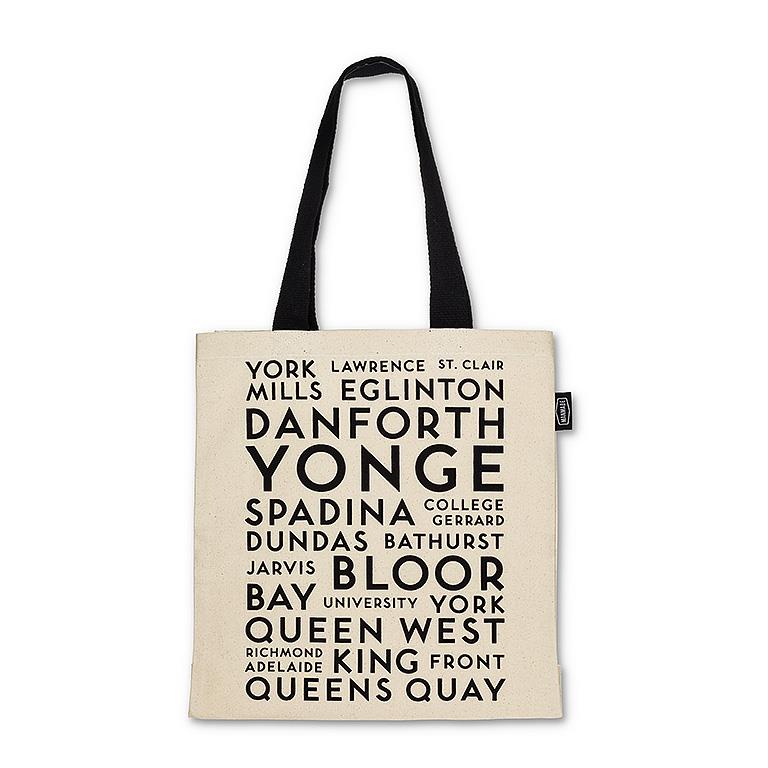 White canvas tote with black handle and text listing Toronto street names.