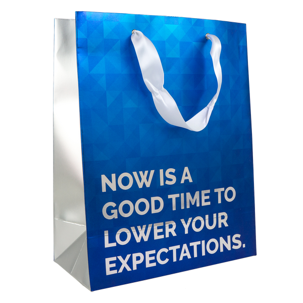 A blue and foil colored gift bag with the words 