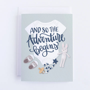 And so the Adventure Begins Baby Shower Card - Handmade Canadian baby shower card with "And So The Adventure Begins" text and soft pastel baby items design, unique gift.