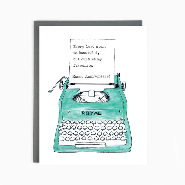 A teal blue typewriter with a paper reading 