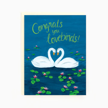 Lovebirds Greeting Card | The Paperhood - Handmade Canadian greeting card with two white swans forming a heart, blue water, and "Congrats you Lovebirds!" text.