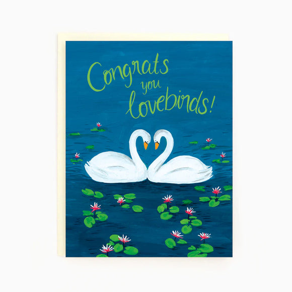 A blue card with 2 swans forming a heart and the words "Congrats you lovebirds"