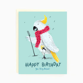 A blue card with a white cockatoo wearing a boa singing into a microphone and the words "Happy Birthday you Party Animal"