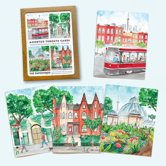 All four card designs laid out next to the packaging 