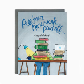 A blue card with a person studying at a desk filled with books and the words "All your hard work paid of...Congratulations!"