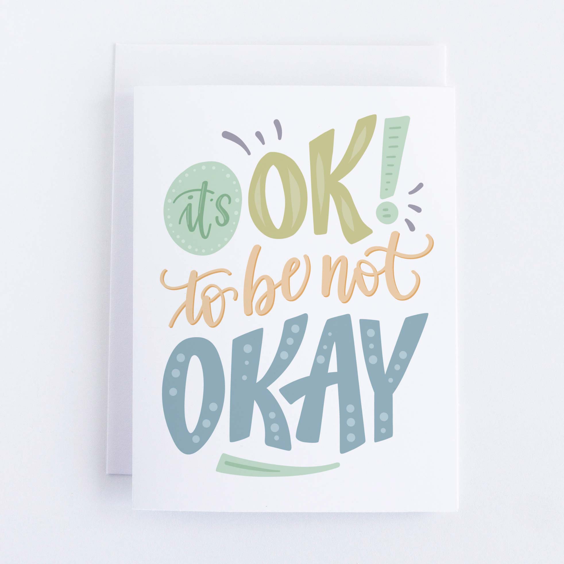 A white card with the words "It's ok to not be okay"