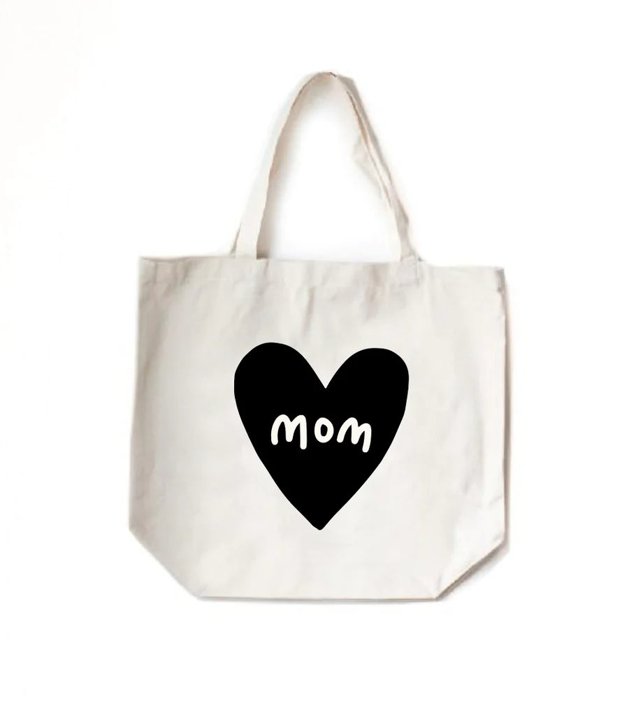 A white tote bag with a black heart and the word "mom" inside the heart