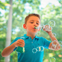 A kid wearing a blue shirt playing with the Kids First Chemistry Set
