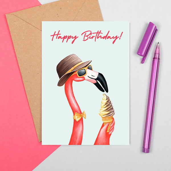 White card with a flamingo wearing a hat and sunglasses eating ice cream and the words 