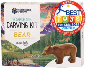 A box with a picture of a brown bear statue in front of an illustrated lake and forest. In the top right corner is a red stamp reading "ASTRA Best toys for kids 2021 winner"