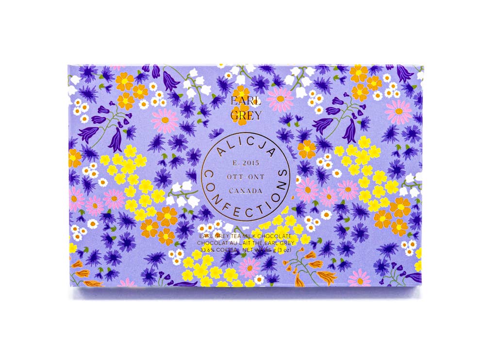 Earl Grey Milk Postcard Chocolate Bar: blue background with small blue, white and yellow flowers