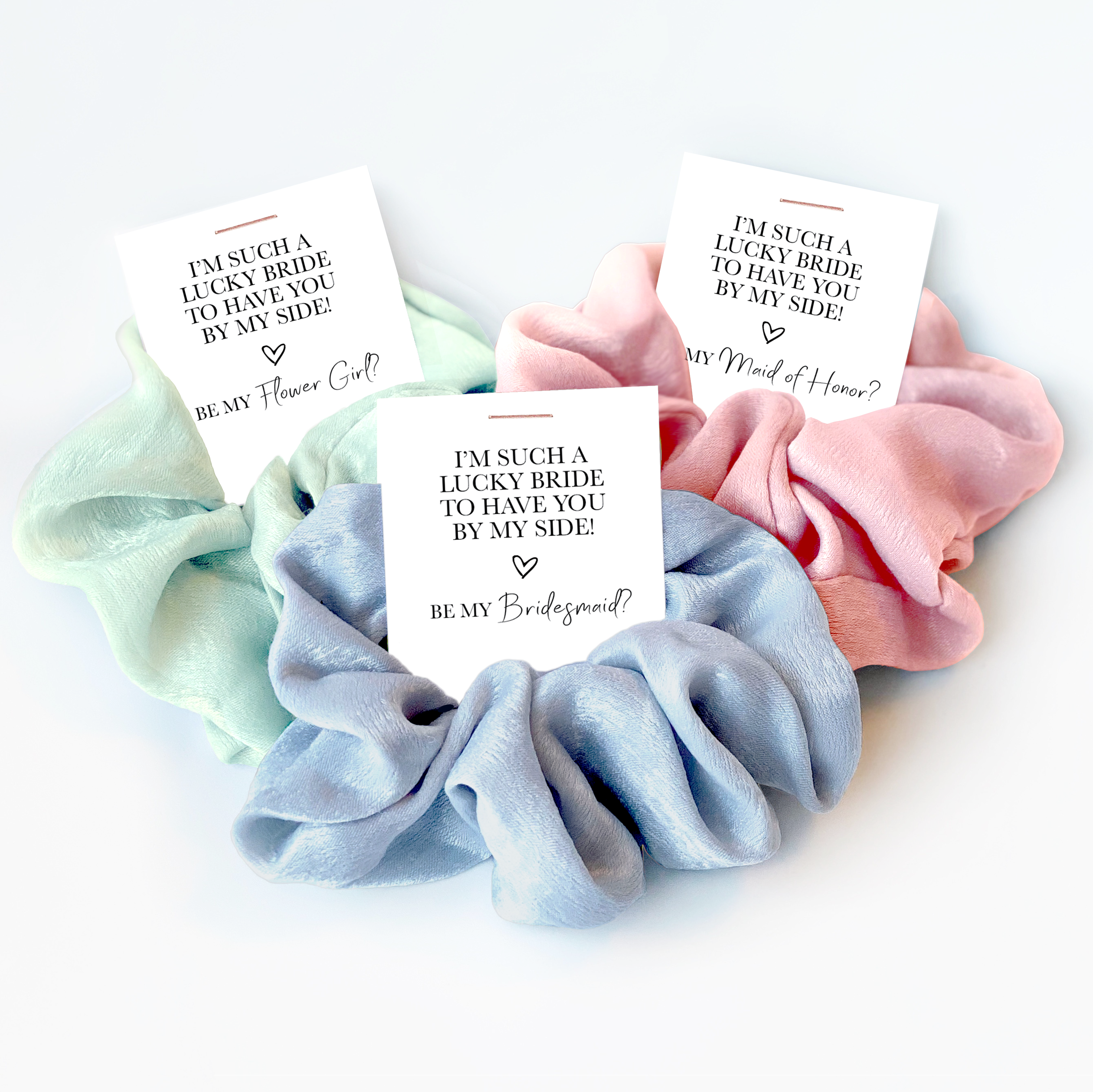 A mint coloured, light blue, and pink scrunchie