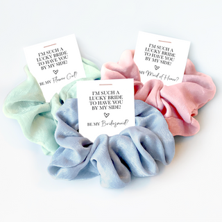 A mint coloured, light blue, and pink scrunchie