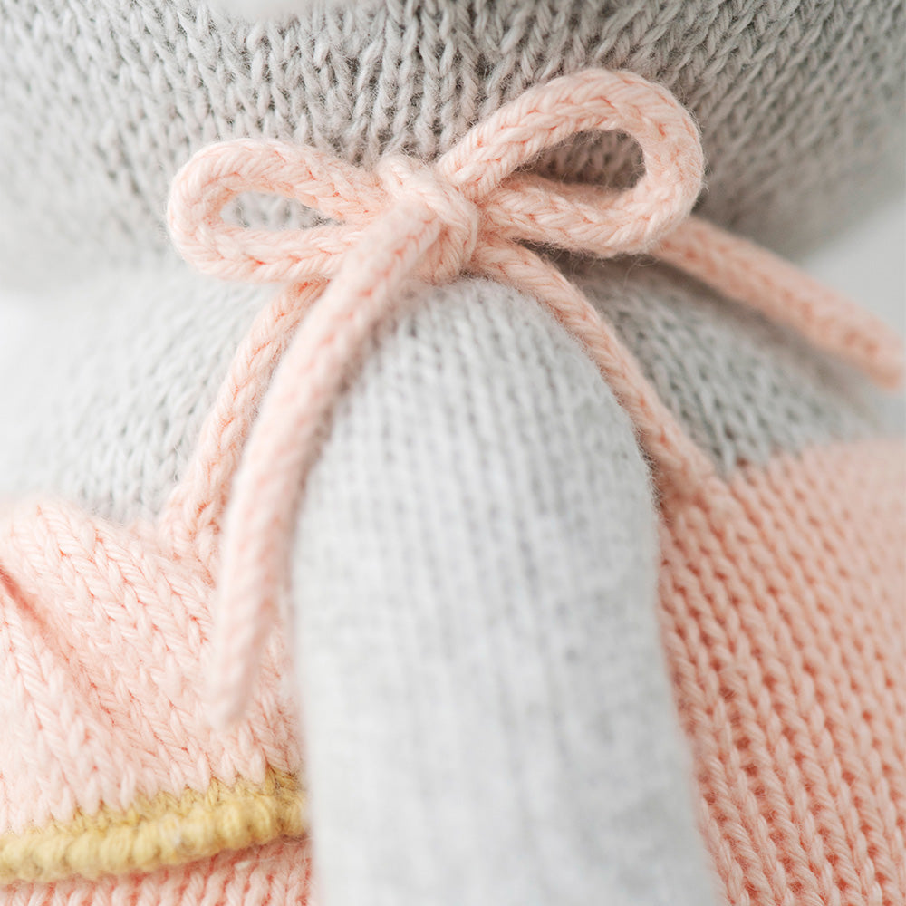 Closeup shot of the pink bow on the dress on the elephant stuffy