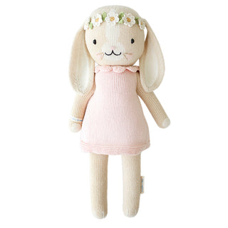 A bunny stuffy wearing a pink dress and flower crown