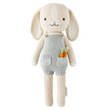 A bunny stuffy wearing blue overalls