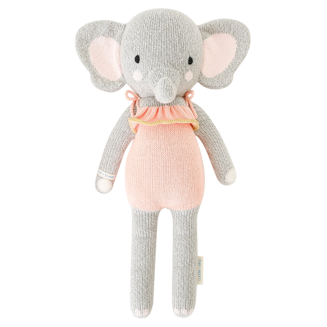 An elephant stuffy wearing a pink dress