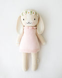  A bunny stuffy wearing a pink dress and flower crown
