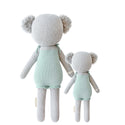 A back shot of the 2 different sized koalas wearing teal dresses 