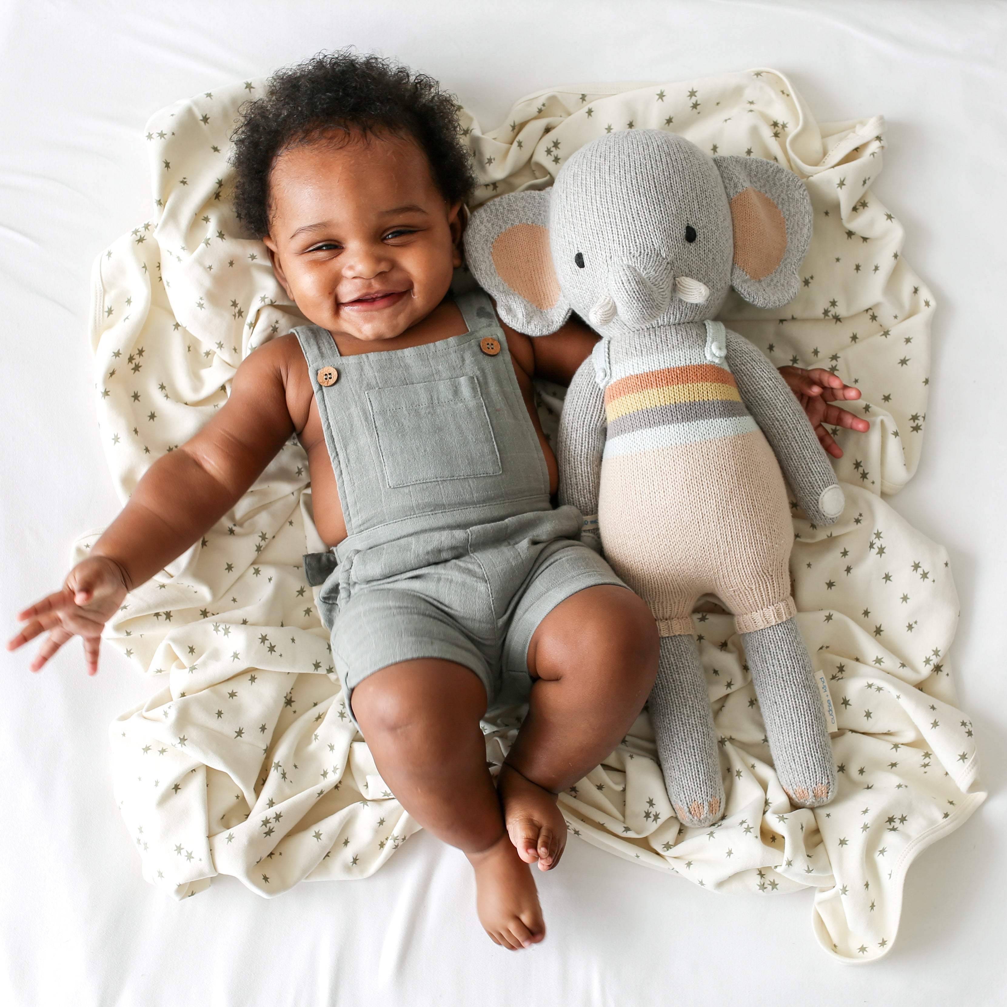 An elephant stuffy beside a baby