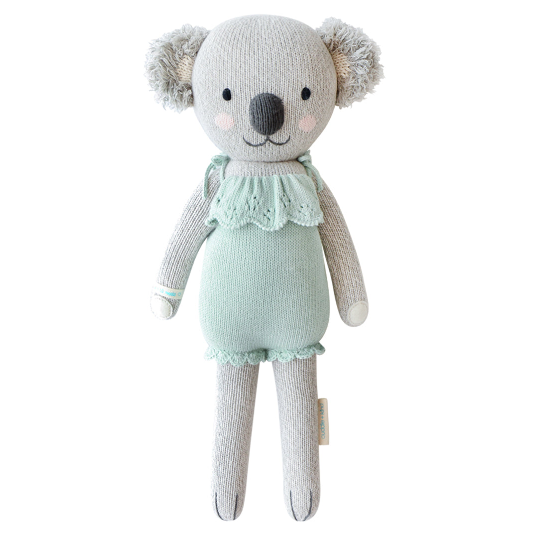 A koala stuffy wearing a teal dress