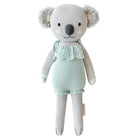 A koala stuffy wearing a teal dress