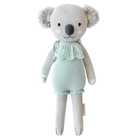 A koala stuffy wearing a teal dress