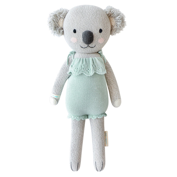 A koala stuffy wearing a teal dress
