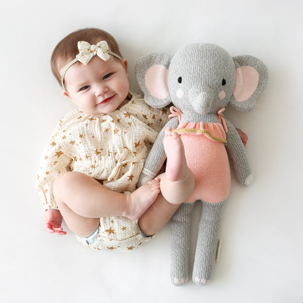 An elephant stuffy beside a baby