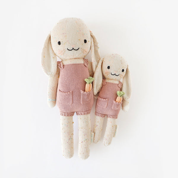 2 different sized bunny stuffies wearing pink dresses