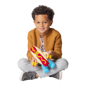 A kid holding the LEGO Hot Dog Guy Plush Minifigure