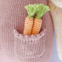 Closeup shot of the pink dress pocket with 2 carrots inside
