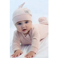 A baby wearing the Mini Waffle Collection - Footed Sleeper - Pink