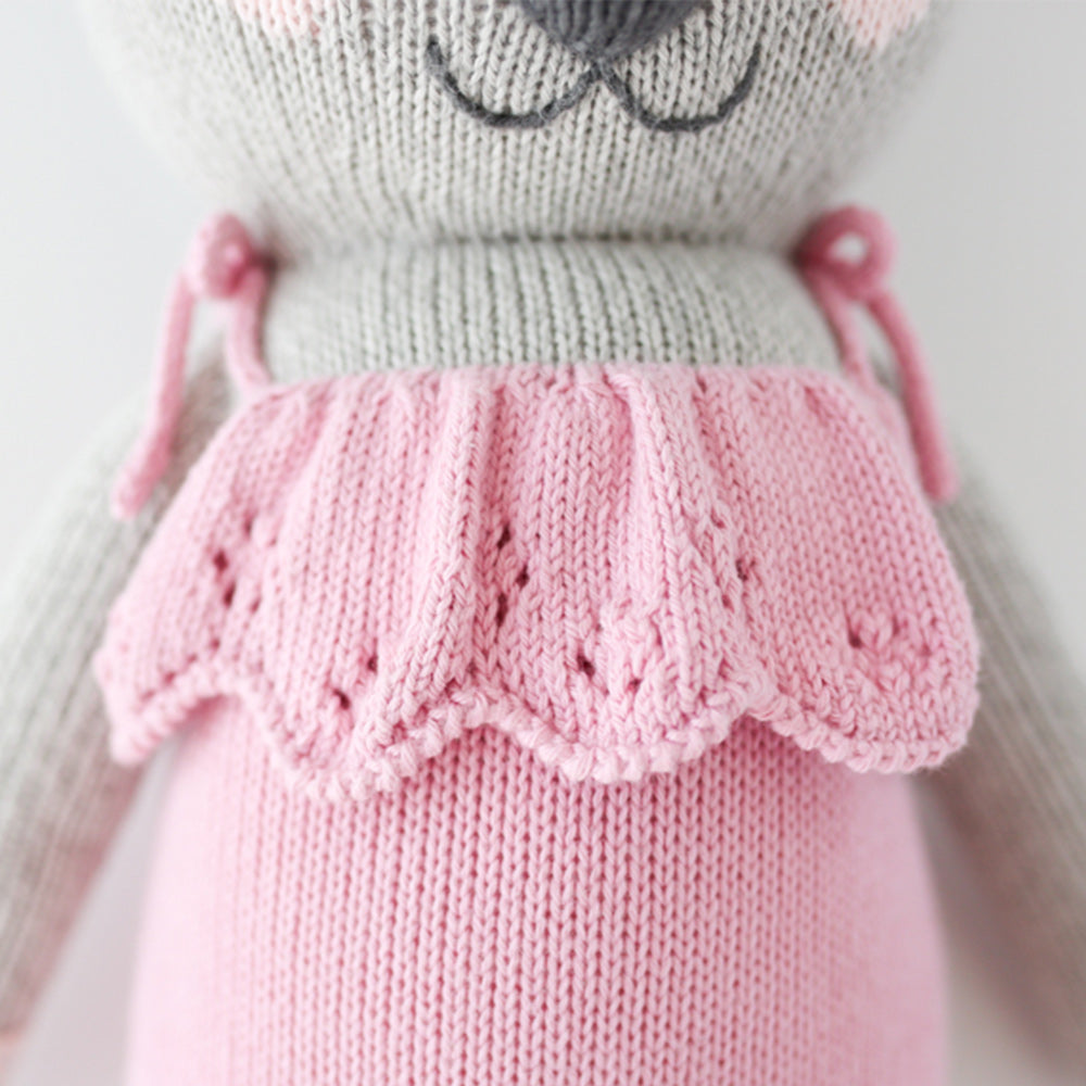 A close up shot of the pink dress on the koala