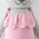 A close up shot of the pink dress on the koala