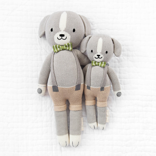  2 different sized dog stuffies wearing beige overalls