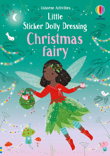 Little Sticker Dolly Dressing: Christmas Fairy - Christmas fairy with dark skin, green leaf skirt, red sweater, wings, holding wreath, nighttime sky background.