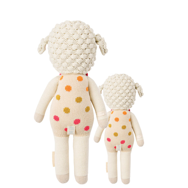  2 different sized lamb stuffies, both in pink polka dot overalls