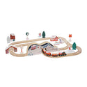 A wooden train track with a red train and Christmas decorations and a barn